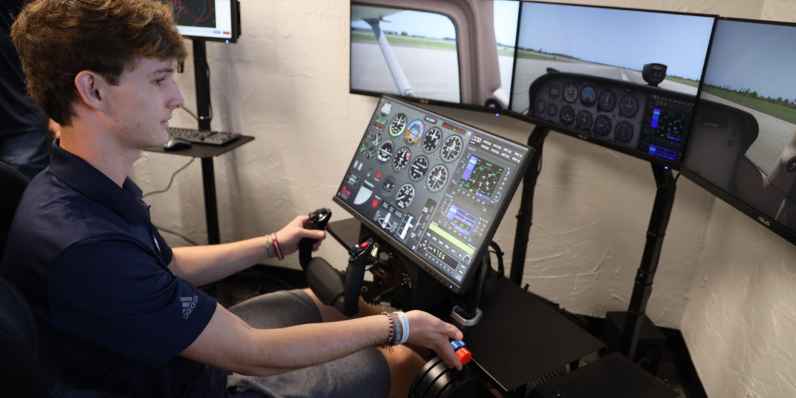 Oklahoma Aviation Academy student using a flight simulator