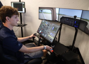 Oklahoma Aviation Academy student using a flight simulator