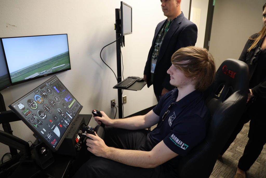 Oklahoma Aviation Academy student using a flight simulator