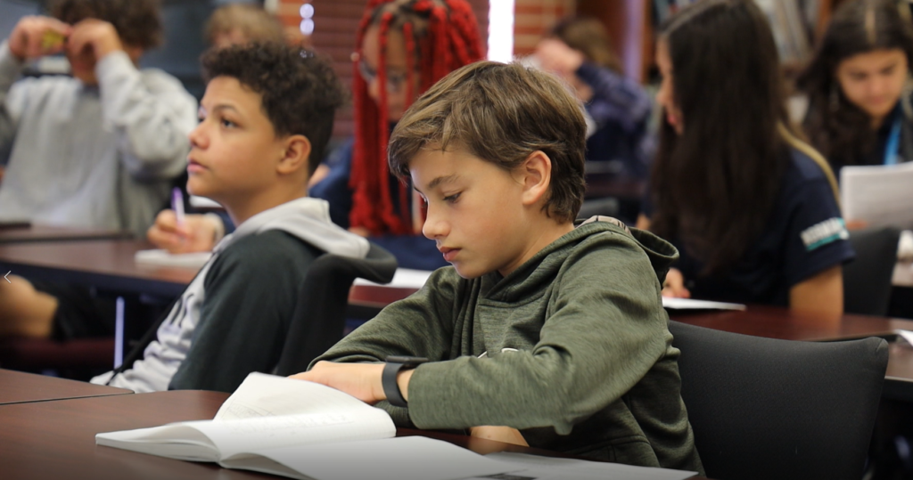 Oklahoma Aviation Academy student sitting at a desk in a class of others