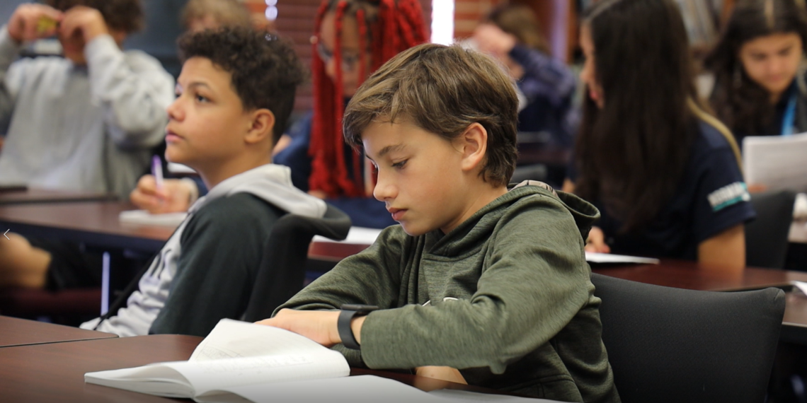 Oklahoma Aviation Academy student sitting at a desk in a class of others