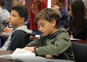 Oklahoma Aviation Academy student sitting at a desk in a class of others