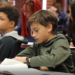 Oklahoma Aviation Academy student sitting at a desk in a class of others