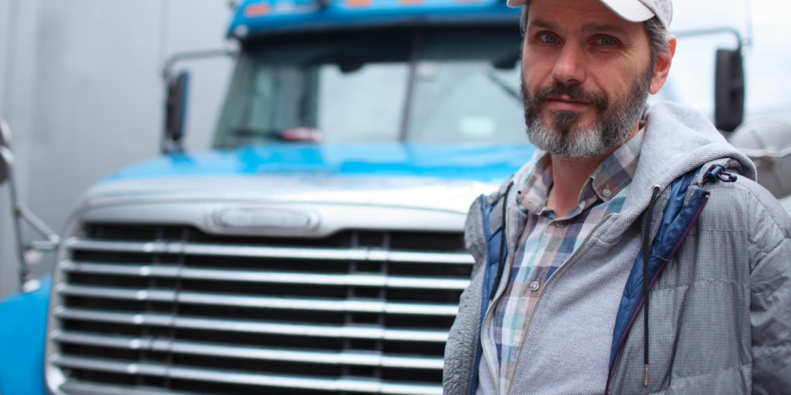 Mature bearded man against retro styled truck