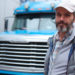 Mature bearded man against retro styled truck