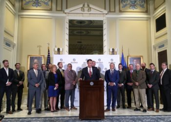 Gov. Kevin Stitt, flanked by legislators, announces a historic education package.