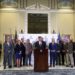 Gov. Kevin Stitt, flanked by legislators, announces a historic education package.