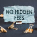 A scrap of blue paper with clips on a gray background with the text - NO HIDDEN FEES.