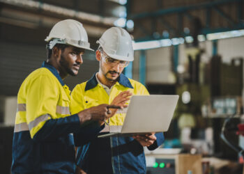 professional technician engineer with safety helmet hard hat working in industrial manufacturing factory, men at work to checking equipment of machinery production technology or construction operating