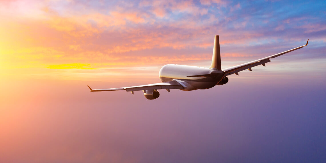 Beautiful sunset cloudy sky from aerial view. Airplane view above clouds