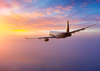 Beautiful sunset cloudy sky from aerial view. Airplane view above clouds