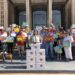 Amber England speaks before she and SQ 832 supporters submit a petition for a minimum wage increase.