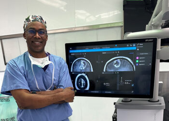 Caple Spence, M.D., standing next to INTEGRIS Health's new Stryker Q technology. Photo from INTEGRIS