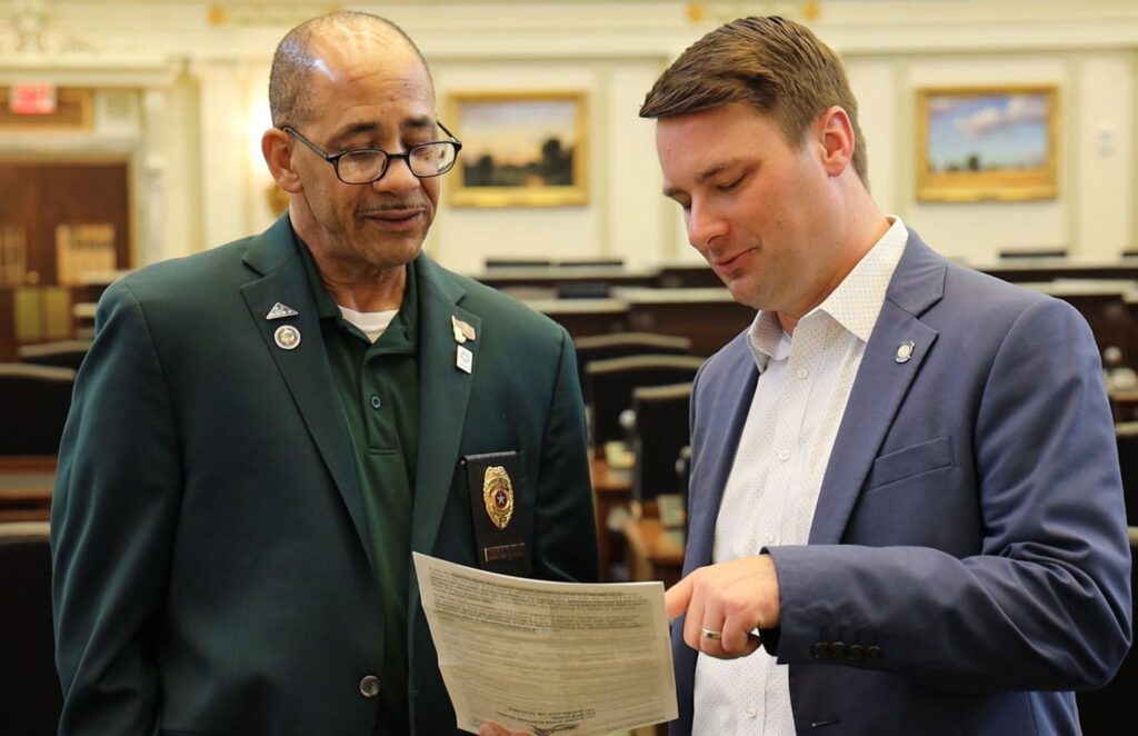 Kyle Hilbert (right) in the House chamber.