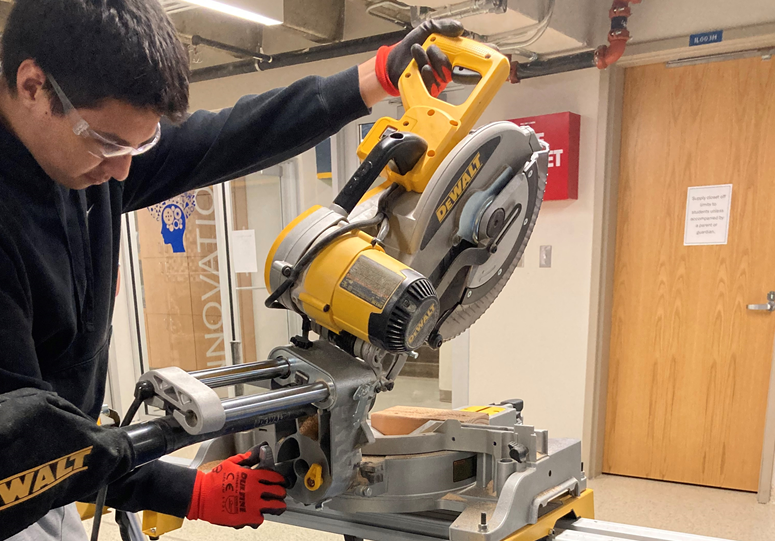 A Bartlesville High School student using a power saw in the Construction Tech course. Photo from Douglas Boudreaux