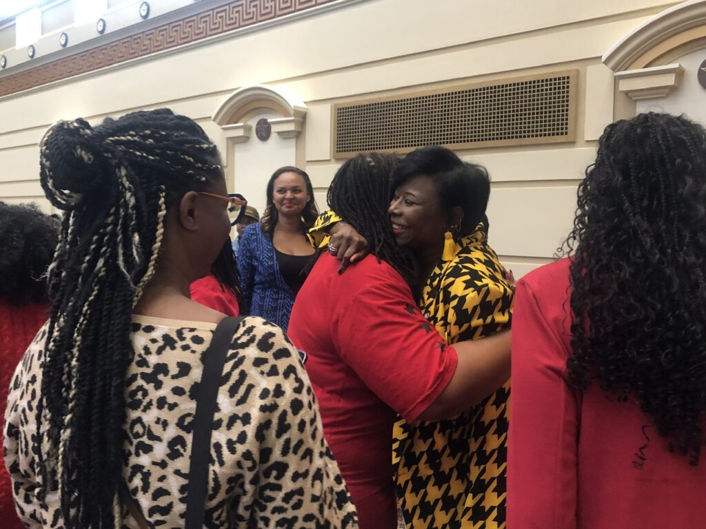 Newly elected Senator Nikki Nice embraces a supporter after the State Senate's swearing in ceremony.