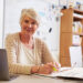Portrait of senior female teacher working at her desk