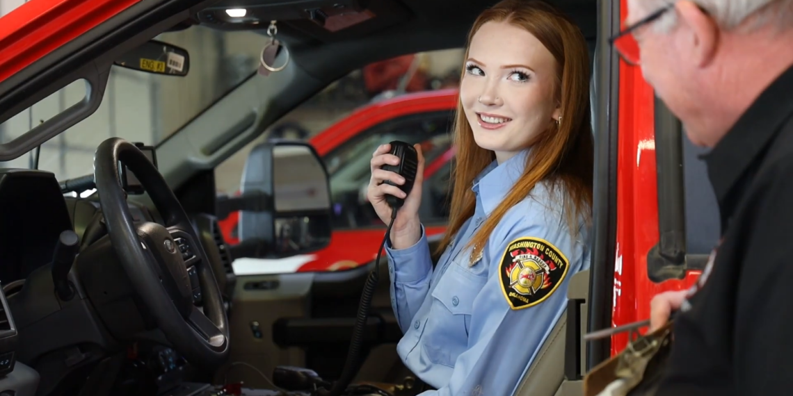 Ella Goodwin behind the wheel of a fire truck.