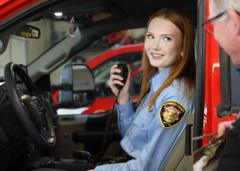 Ella Goodwin behind the wheel of a fire truck.