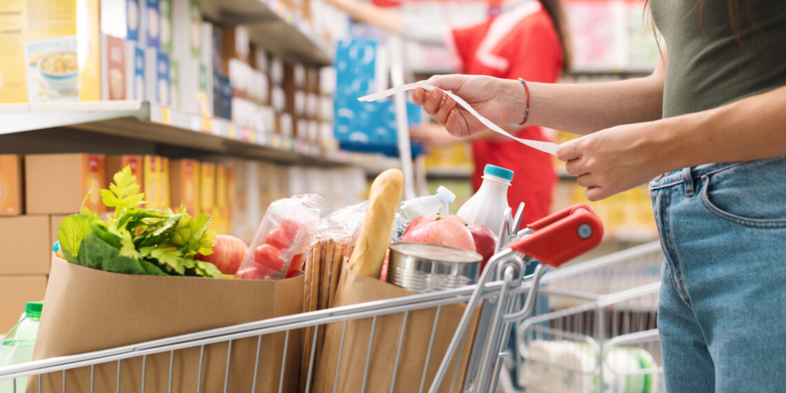 Woman checking the grocery receipt