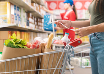 Woman checking the grocery receipt