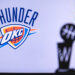 NEW YORK, USA, JUN 18, 2020: Oklahoma City Thunder Basketball club on the white screen. Silhouette of NBA trophy in foreground.