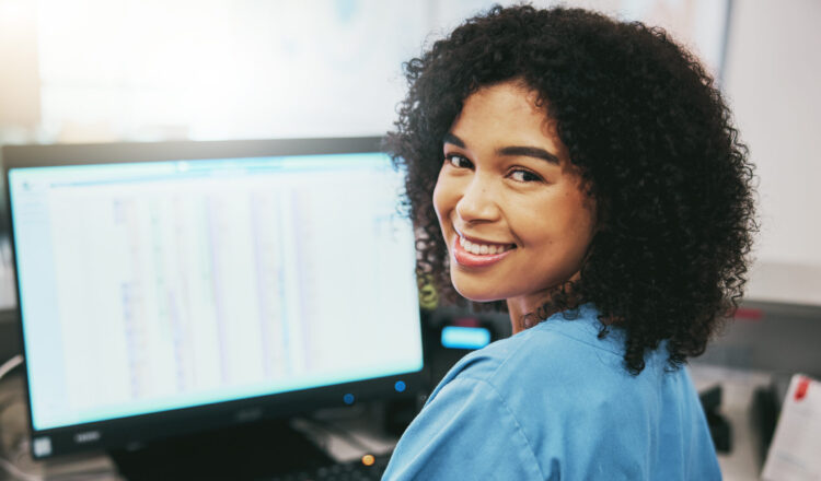 Portrait, nurse and receptionist at hospital on a computer working at her desk or table in an office as a black woman. Medical, healthcare professional or worker smile, happy and excited at work.