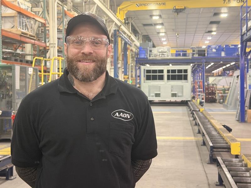 Wes Crawford standing on the production floor at AAON in Tulsa