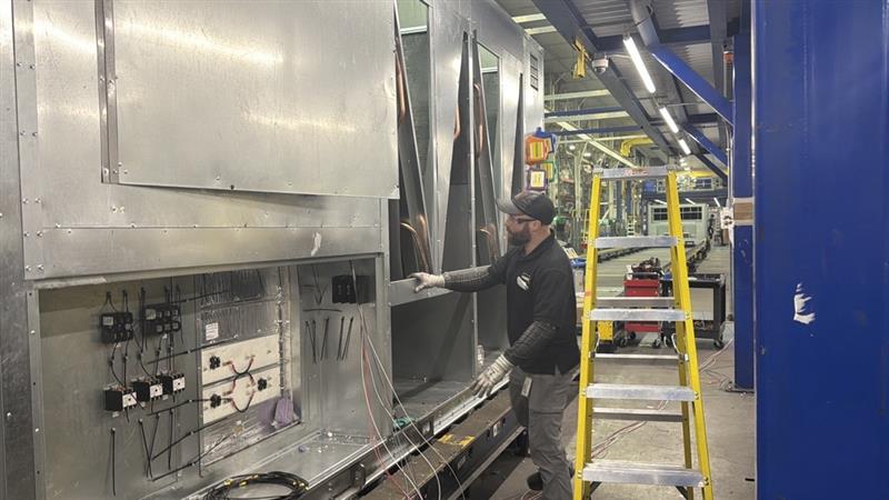 Wes Crawford working on manufacturing equipment on the production floor at AAON in Tulsa