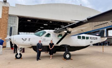 Sen. Paul Rosino and Rep. Emily Gise beside the Joby J208 outside an airport hangar.
