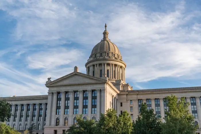 The dome and south facade of the Oklahoma State Capitol beneath a blue sky
